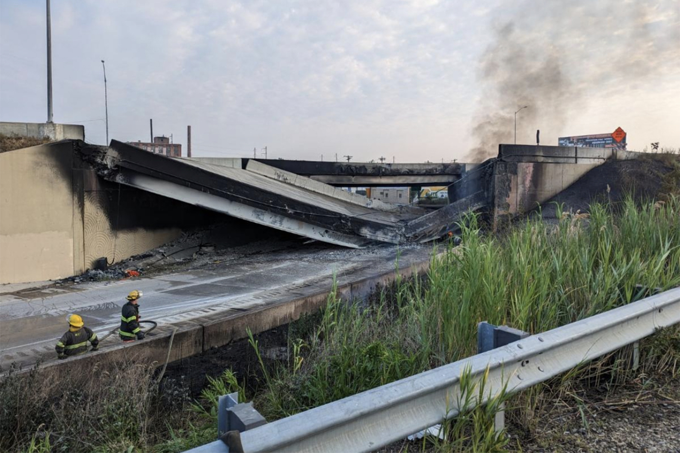 PHILADELPHIA, PA - JUNE 11: In this handout photo provided by the City of Philadelphia Office of Emergency Management, smoke rises from a collapsed section of the I-95 highway on June 11, 2023 in Philadelphia, Pennsylvania. According to reports, a tanker fire underneath the highway caused the road to collapse. (Photo by City of Philadelphia via Getty Images)