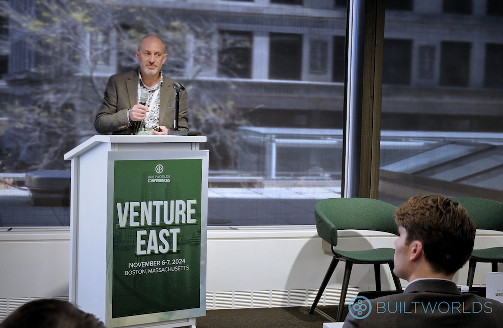 CALMFLOOR CEO Paul Reynolds speaks from behind a podium at Venture East Conference 2024