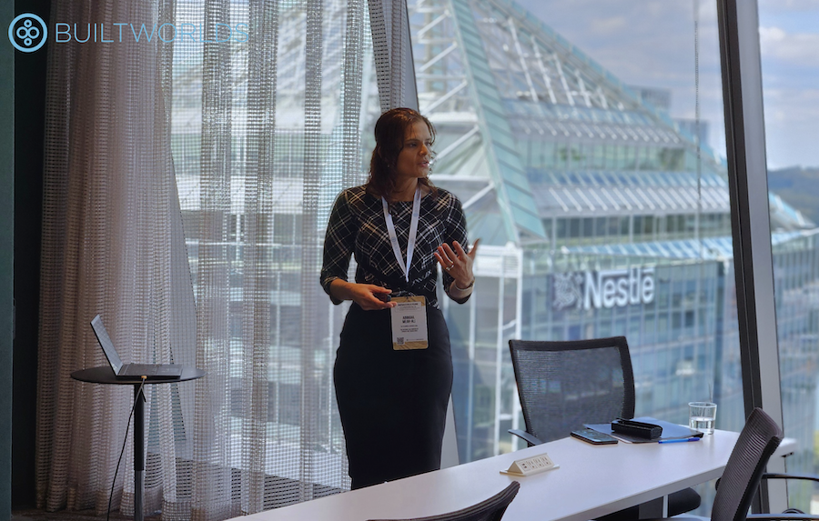 Professional woman leads discussion in front of view during the 2025 Infrastructure Conference by BuiltWorlds