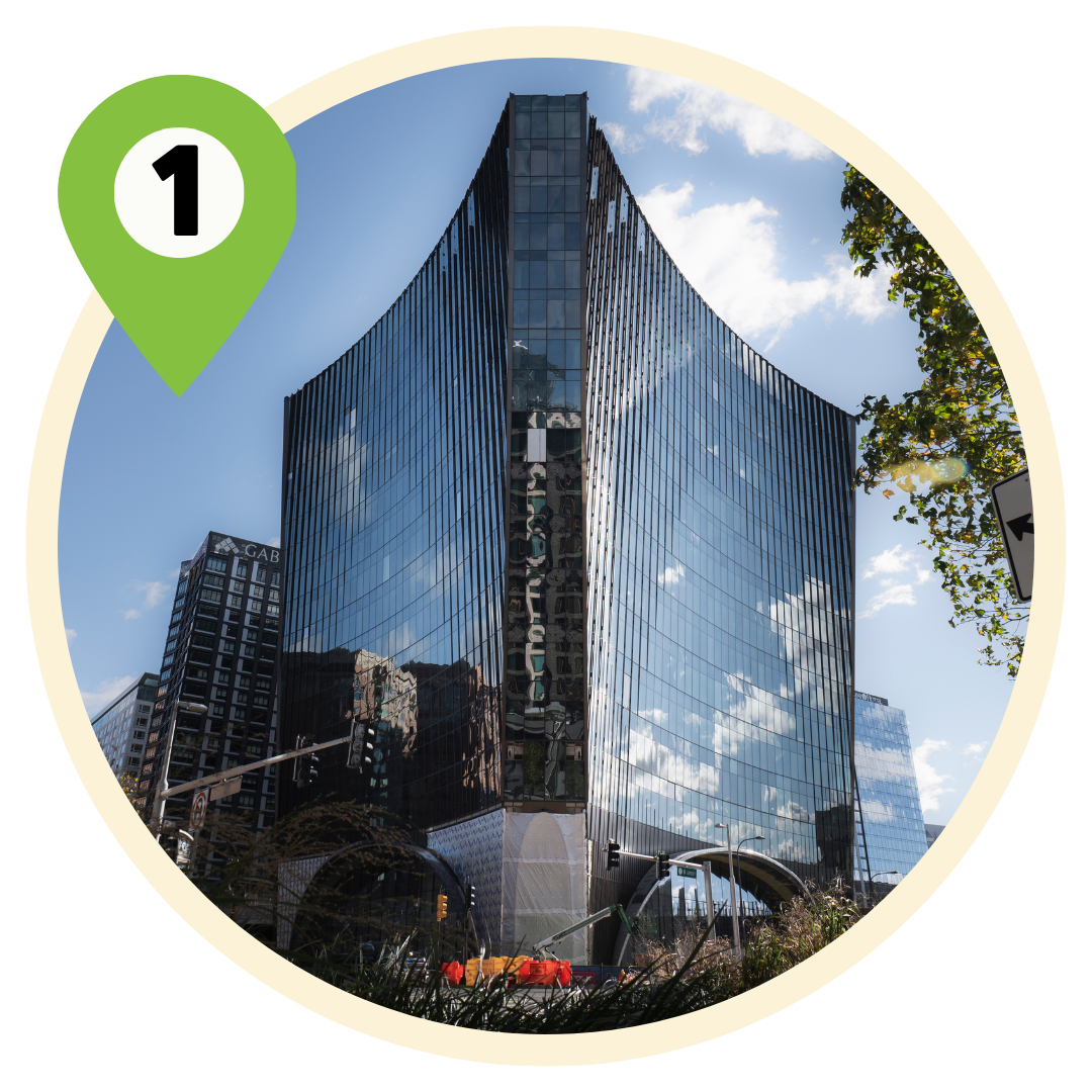 Exterior shot of 10 World Trade building made of metal and glass reflecting the blue sky and clouds in Boston