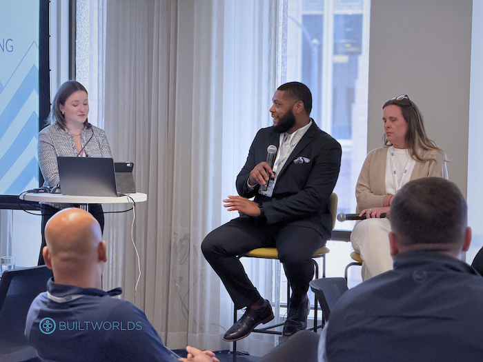 Man and two women on stage during the Chicago Global Summit conference put on by BuiltWorlds