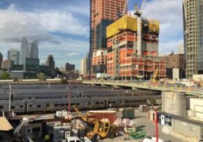 Trains pass under the Hudson Yards development. (Source: Walker Thisted, BuiltWorlds)