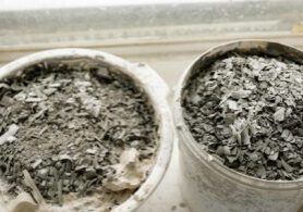 Two buckets of concrete chips and other construction waste.